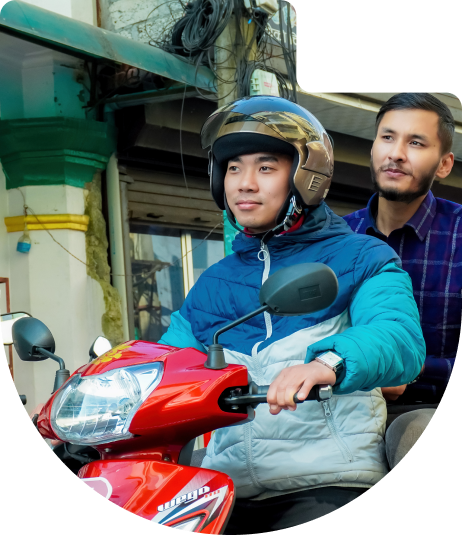 Aayo driver and passenger on bike in Pokhara